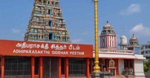Melmaruvathur Temple Irumudi Adhiparasakthi Siddhar Peetam temple gopuram and golden flagpole in bright daylight