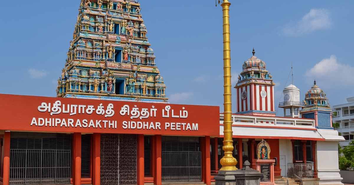 Melmaruvathur Temple Irumudi Adhiparasakthi Siddhar Peetam temple gopuram and golden flagpole in bright daylight